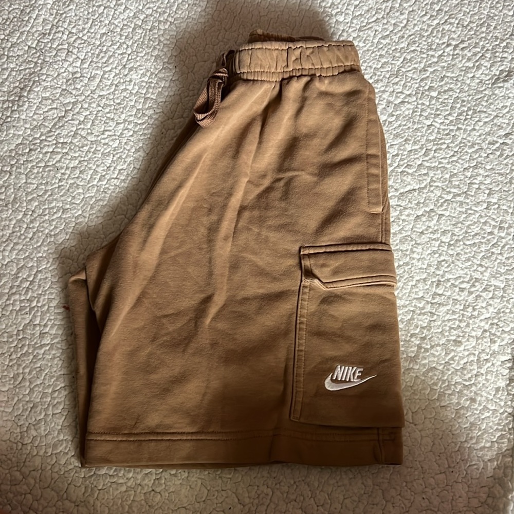 Nike tan colored shorts for men and women, they are a bit cargo, have been used